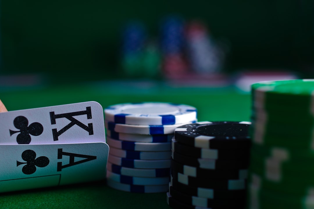 Close-up of playing cards and poker chips on a green felt table